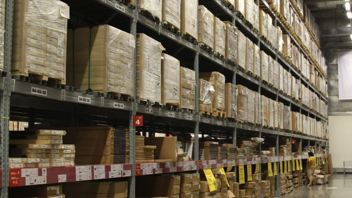 Hundreds of cardboard boxes in a huge warehouse